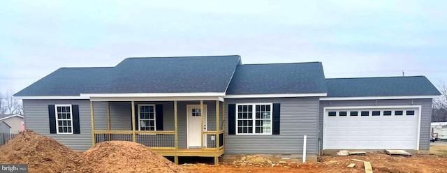 view of front of property featuring a porch and a garage