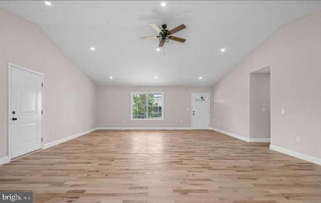 unfurnished living room with ceiling fan, high vaulted ceiling, and light hardwood / wood-style floors