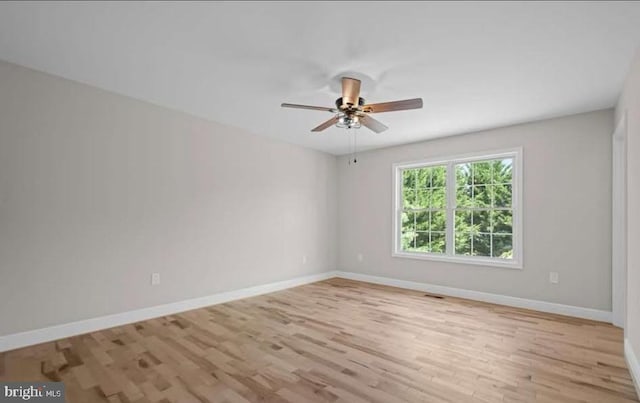 spare room featuring light hardwood / wood-style floors and ceiling fan