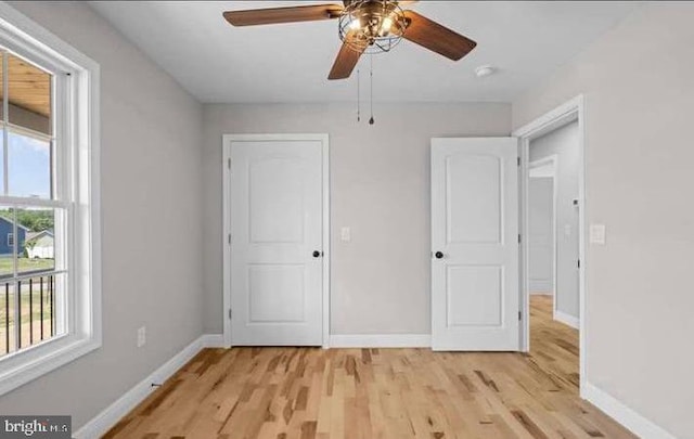 unfurnished bedroom featuring ceiling fan and light wood-type flooring