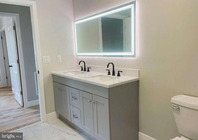 bathroom featuring vanity and toilet