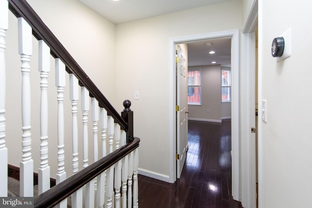 corridor with dark hardwood / wood-style flooring