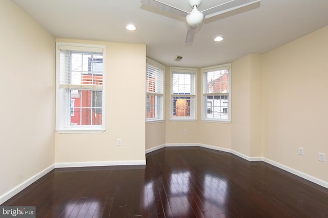 unfurnished room featuring dark wood-type flooring and ceiling fan