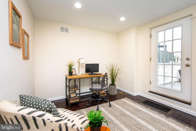 home office with dark wood-type flooring