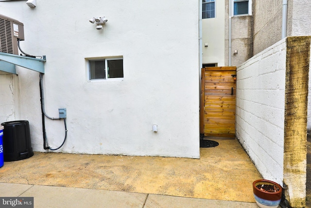 view of side of home with central air condition unit