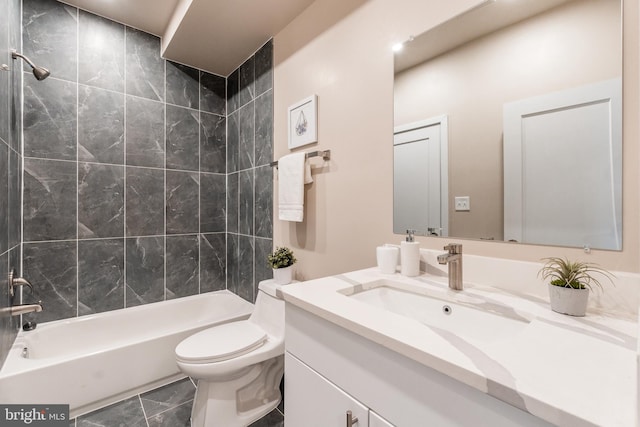 full bathroom with tile patterned flooring, vanity, toilet, and tiled shower / bath