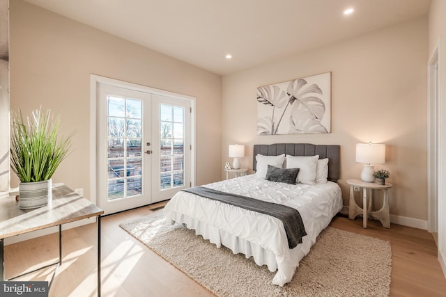 bedroom featuring light wood-type flooring, access to outside, and french doors