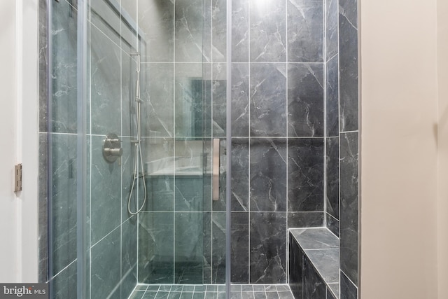 bathroom with tiled shower