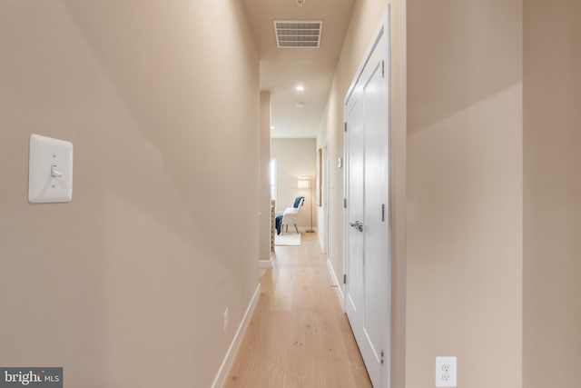 corridor with light hardwood / wood-style floors