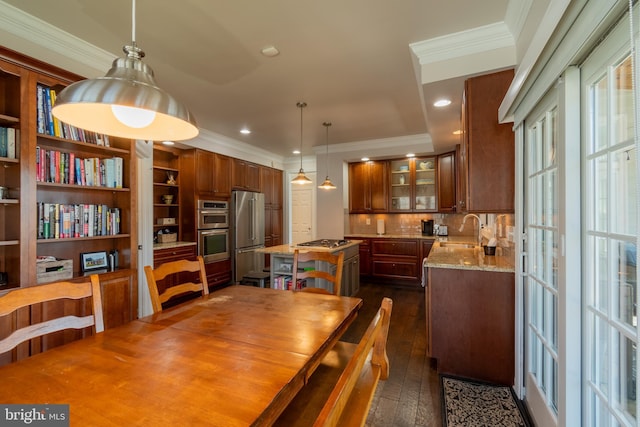 dining area with crown molding, sink, and dark hardwood / wood-style floors