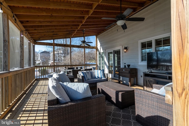 sunroom / solarium featuring ceiling fan and a wealth of natural light