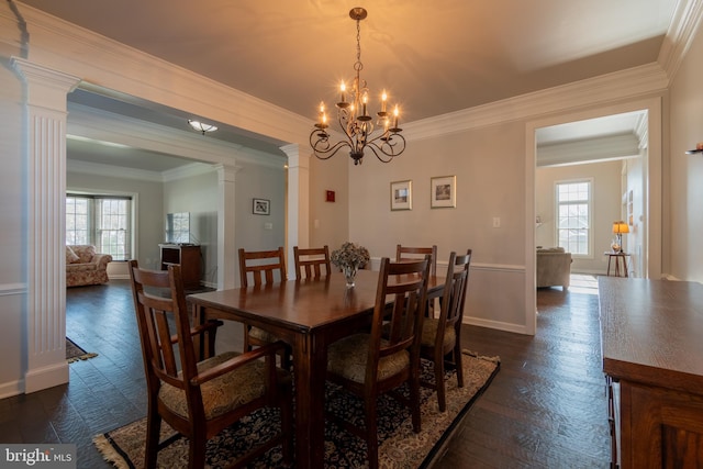 dining room featuring decorative columns, crown molding, and a healthy amount of sunlight