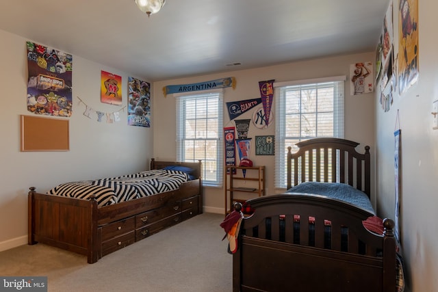 carpeted bedroom with multiple windows