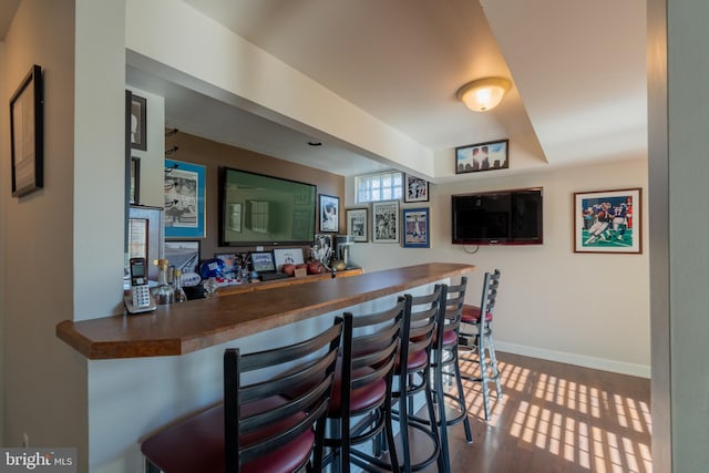 bar with hardwood / wood-style flooring