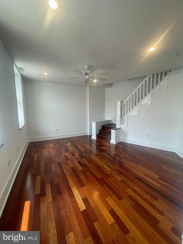 unfurnished living room featuring dark hardwood / wood-style floors and ceiling fan