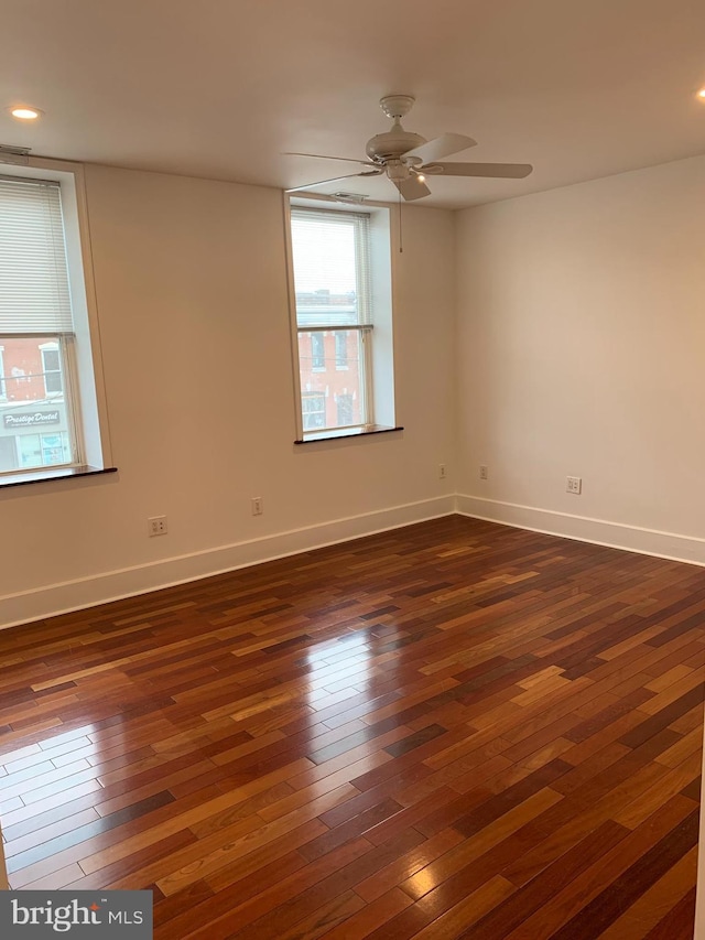 spare room featuring ceiling fan and dark hardwood / wood-style flooring