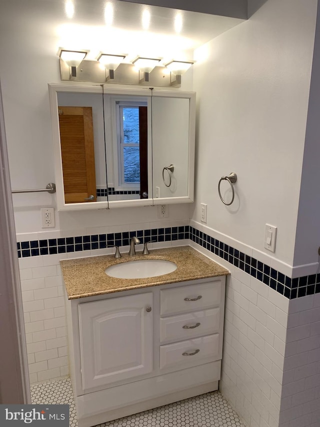 bathroom featuring tile patterned floors, vanity, and tile walls