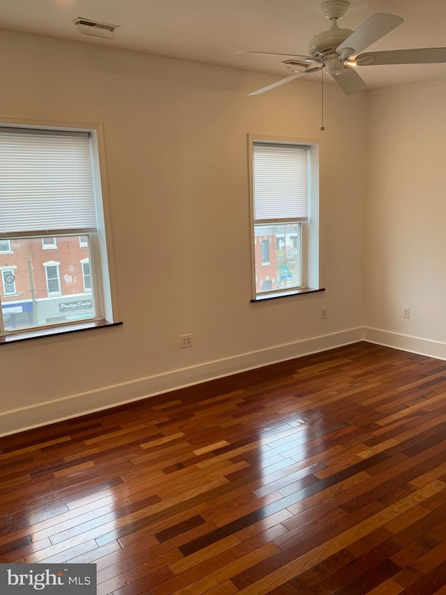 unfurnished room with dark hardwood / wood-style floors and ceiling fan