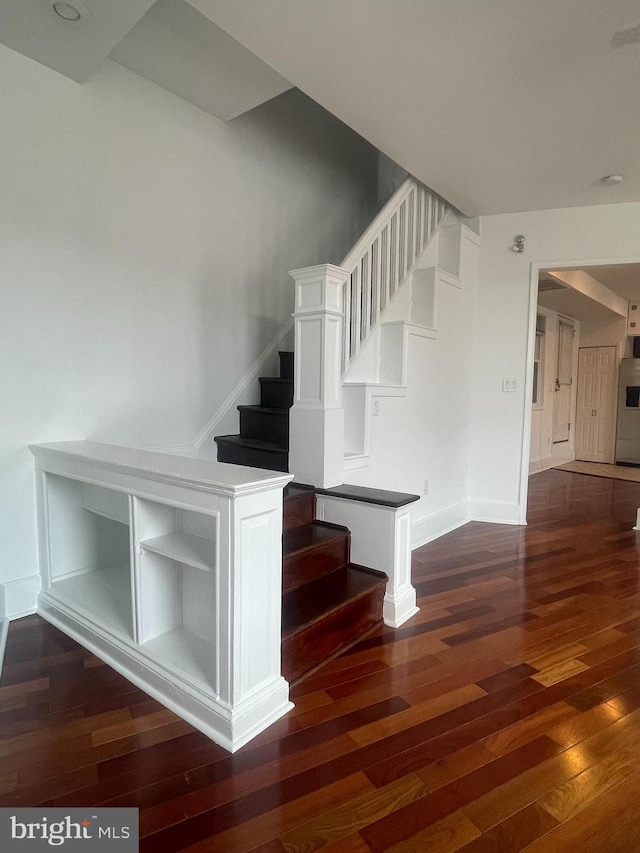 stairway with hardwood / wood-style flooring