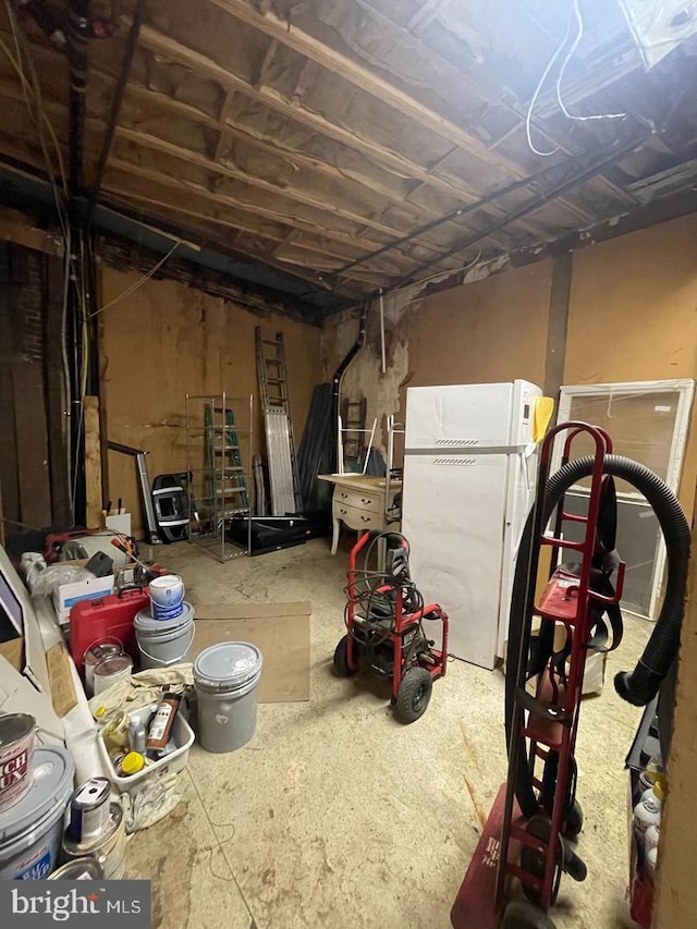 basement featuring white refrigerator