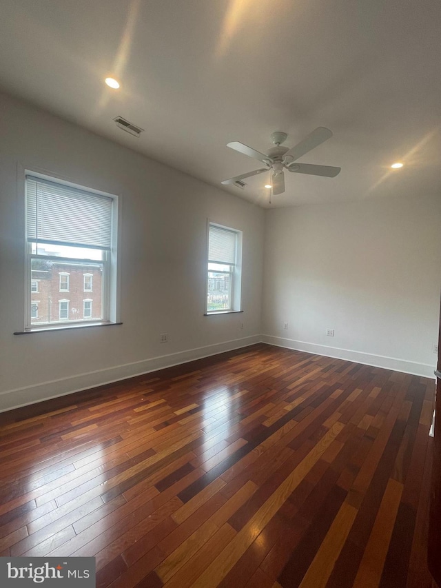 unfurnished room with dark hardwood / wood-style floors and ceiling fan