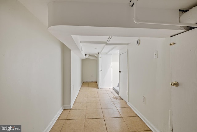 hall featuring light tile patterned flooring