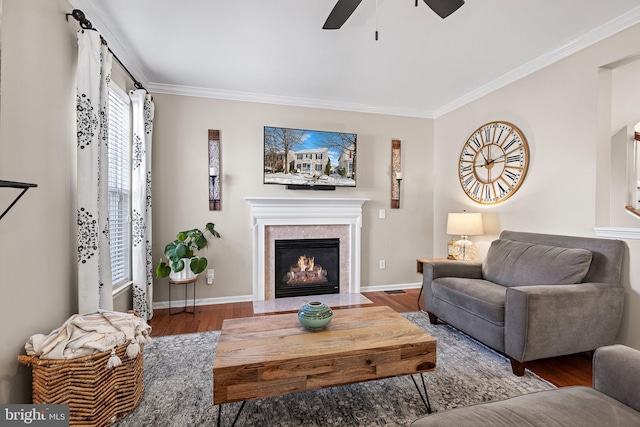 living room with ceiling fan, wood-type flooring, and ornamental molding