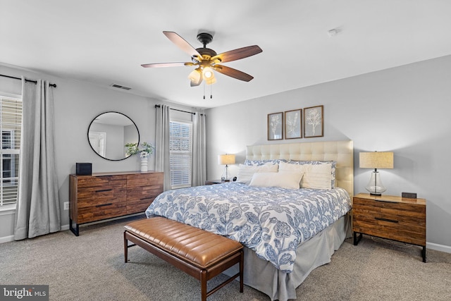 bedroom with ceiling fan and light colored carpet