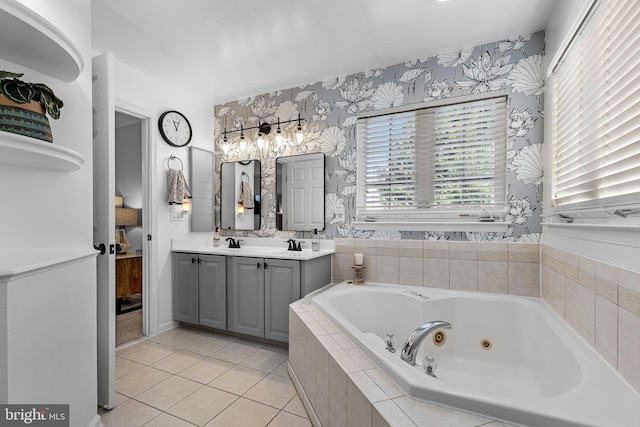 bathroom with tiled bath, tile patterned flooring, and vanity