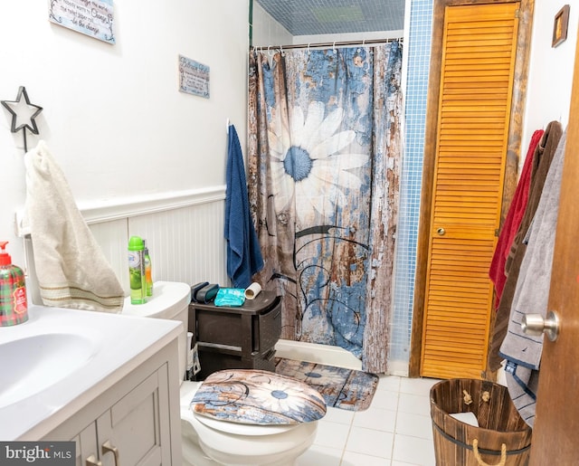 bathroom with tile patterned flooring, vanity, toilet, and a shower with shower curtain