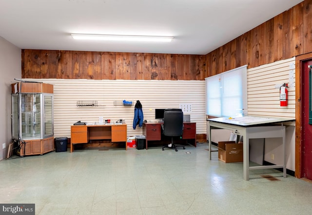 office with a workshop area and wood walls