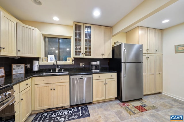 kitchen featuring decorative backsplash, light brown cabinets, sink, and appliances with stainless steel finishes