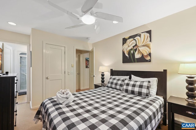 bedroom with ceiling fan and light colored carpet