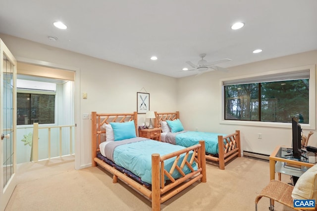 bedroom featuring light colored carpet, an AC wall unit, ceiling fan, and a baseboard heating unit