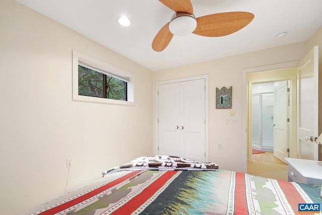 bedroom with ceiling fan and a closet