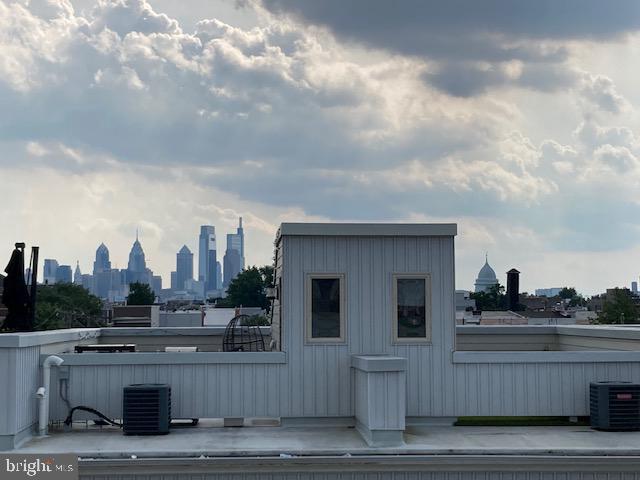 view of home's exterior with central air condition unit and a patio area