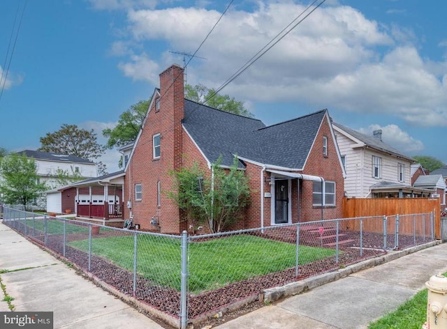 view of front of home featuring a fenced front yard, a chimney, roof with shingles, a front lawn, and brick siding