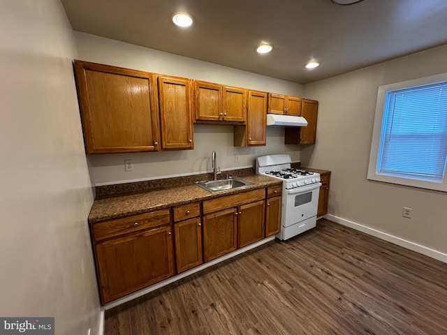 kitchen featuring white gas range, sink, and dark hardwood / wood-style flooring