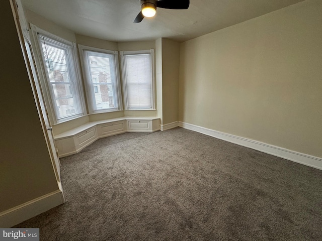 carpeted empty room featuring ceiling fan