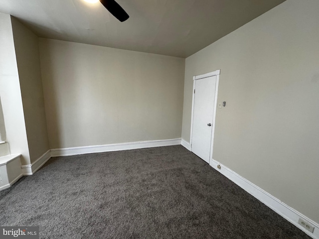 carpeted spare room featuring ceiling fan