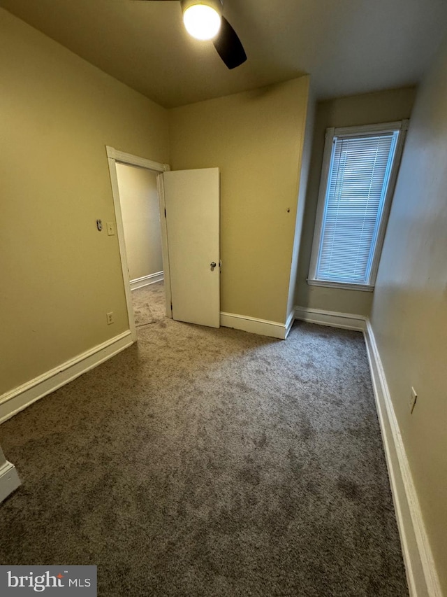 unfurnished bedroom with carpet floors and ceiling fan