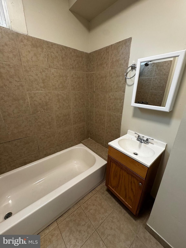 bathroom with tile patterned floors, vanity, and washtub / shower combination