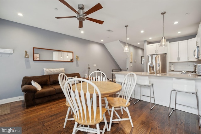 dining space featuring ceiling fan and dark hardwood / wood-style floors