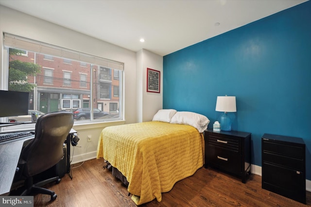 bedroom with dark hardwood / wood-style floors