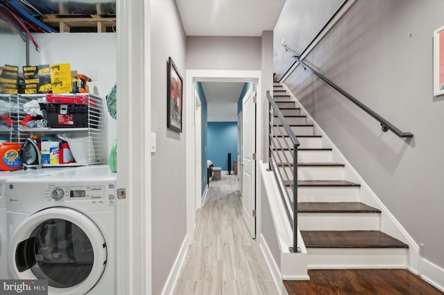 clothes washing area featuring washer / dryer and wood-type flooring