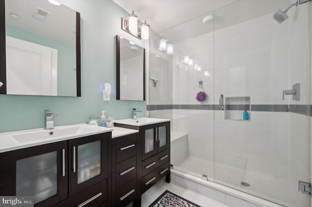 bathroom featuring tile patterned floors, vanity, and a shower with shower door