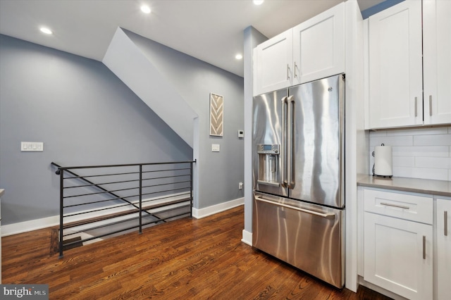 kitchen featuring decorative backsplash, high end refrigerator, white cabinets, and dark hardwood / wood-style floors