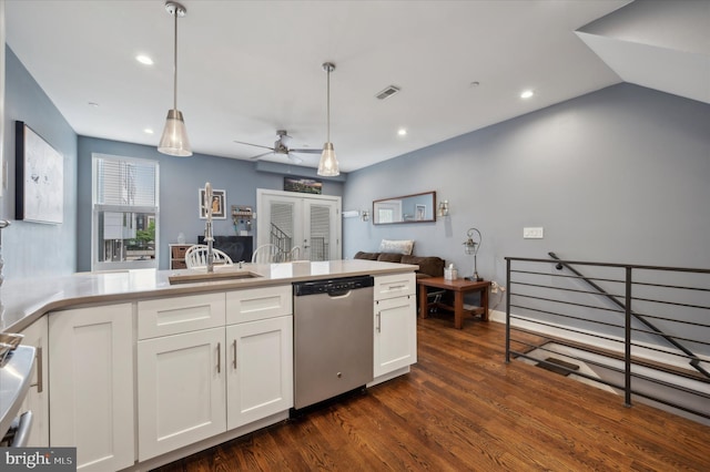 kitchen featuring dark hardwood / wood-style flooring, stainless steel dishwasher, sink, decorative light fixtures, and white cabinetry