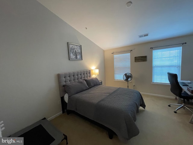 carpeted bedroom with vaulted ceiling