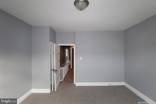 unfurnished room featuring light colored carpet